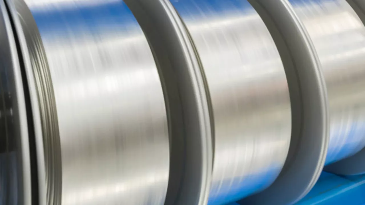 Close-up image of shiny, metallic industrial rollers, reflecting light.