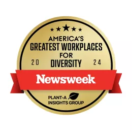 A gold circular badge with a red ribbon across it reads "America's Greatest Workplaces for Diversity 2024" at the top. Below the ribbon is the Newsweek logo and a small leaf icon with the text "Plant-A Insights Group.