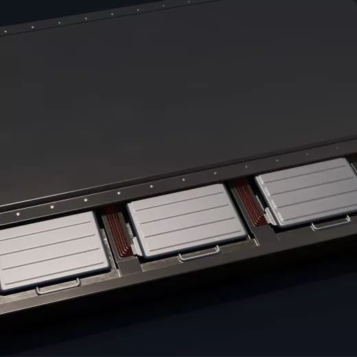 Close-up view of multiple rectangular battery packs aligned in a row within a metallic enclosure. The battery packs are silver with horizontal grooves and are connected to wiring. The top part of the image shows a dark, smooth surface.